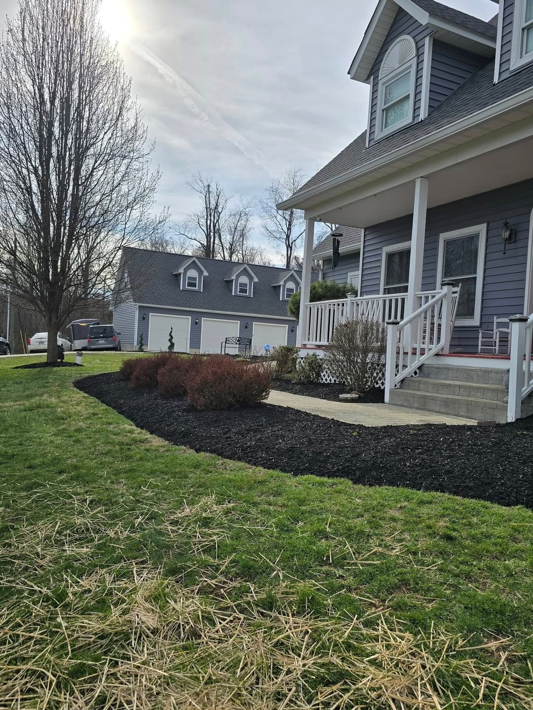 Charming home exterior with landscaping, driveway, and peaceful surroundings on a sunny day.