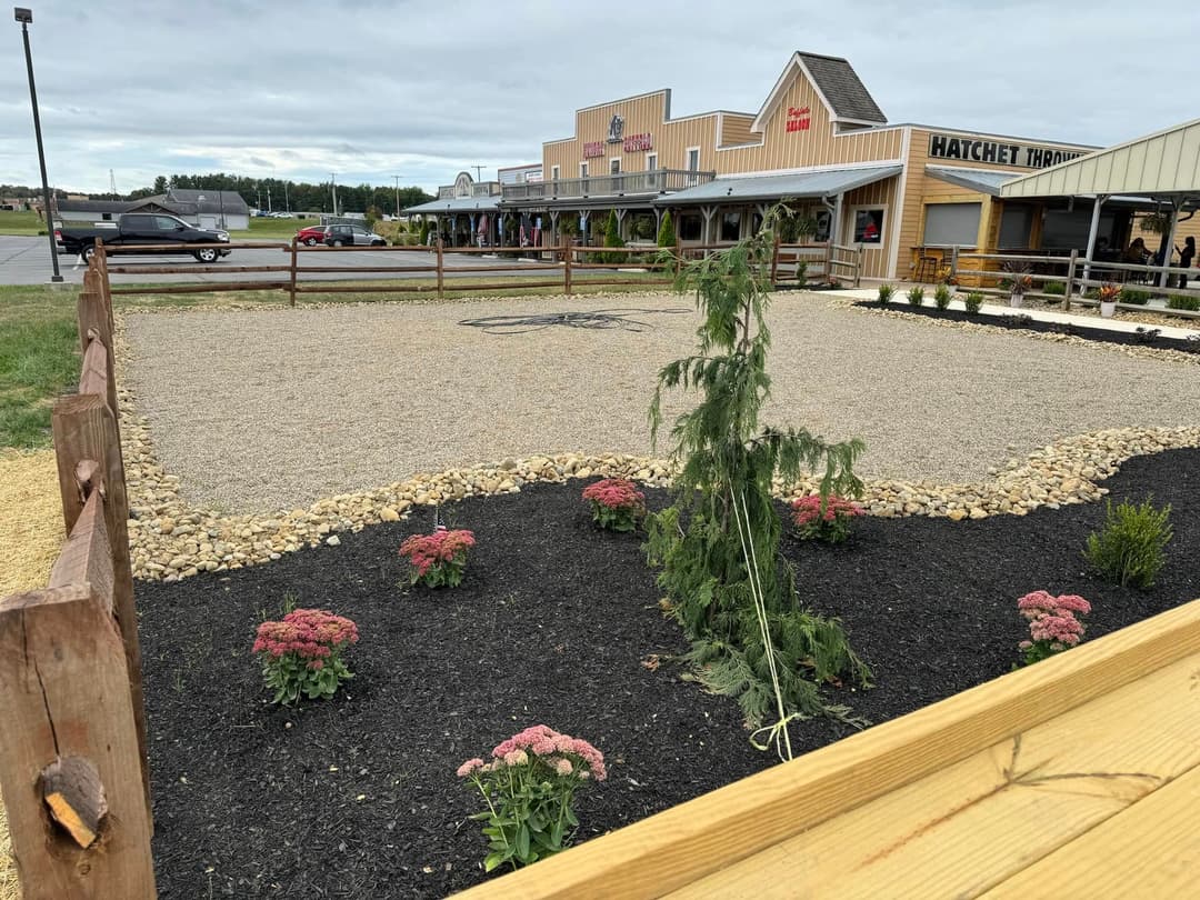 Gravel garden landscape with flowers and nearby stores at Hatchet House location.
